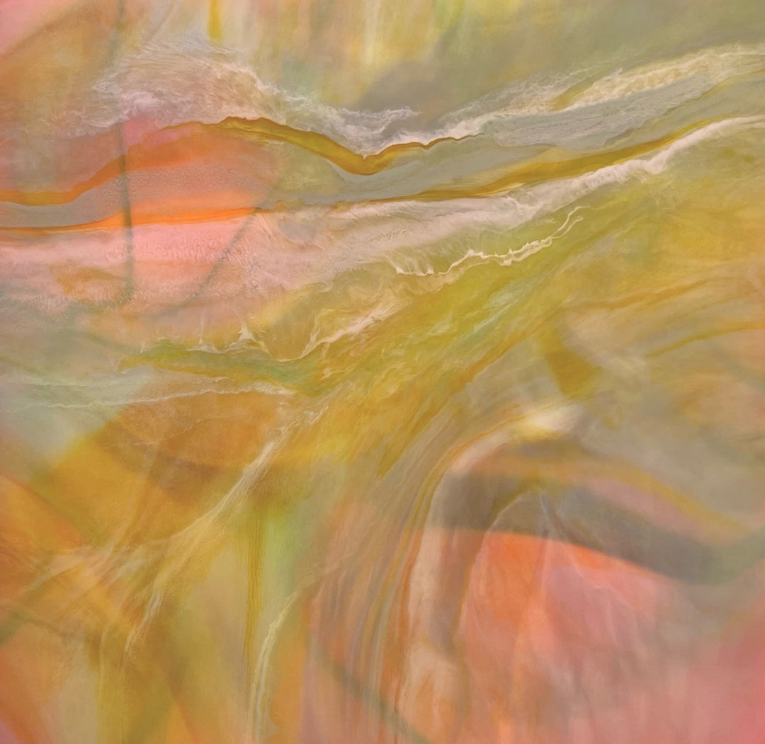 Abstract artwork with swirling colors in orange, yellow, and green.