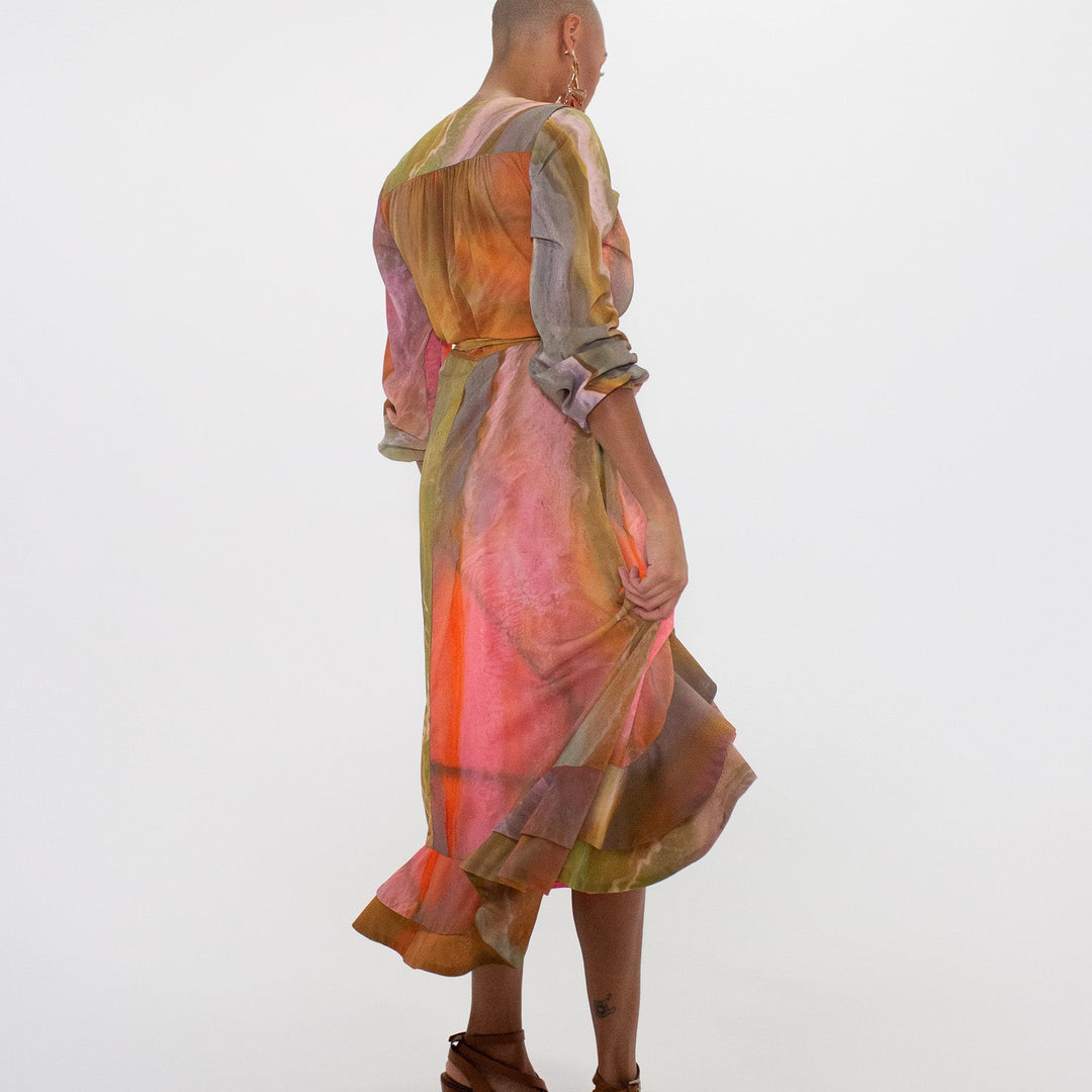 Statue of a person wearing a colorful dress on a white background