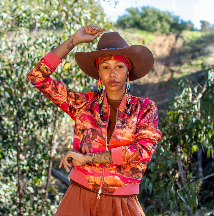 Person wearing a colorful outfit with a hat in a natural setting