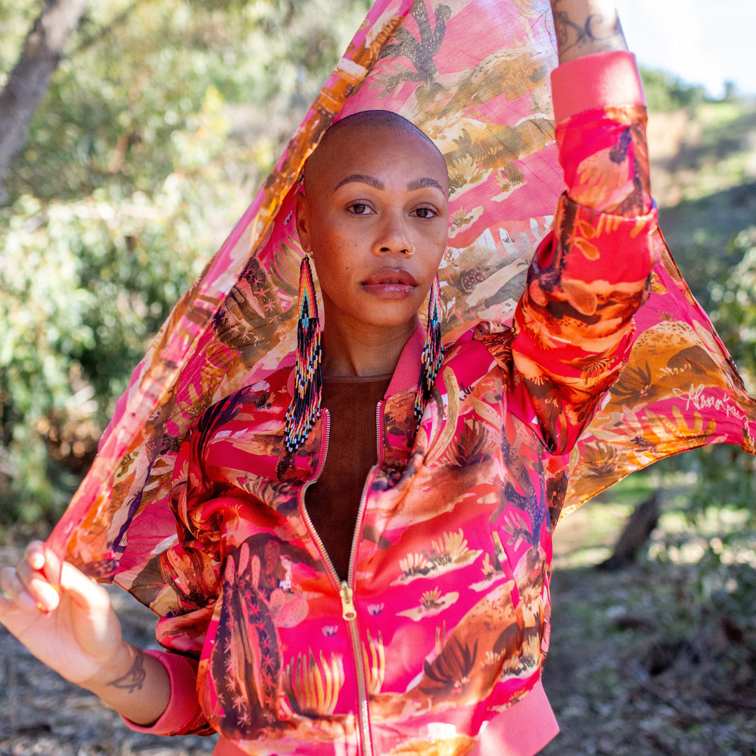 Person wearing a colorful jacket with a floral pattern outdoors